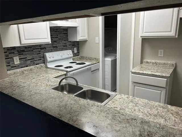 a kitchen with a sink stove and refrigerator