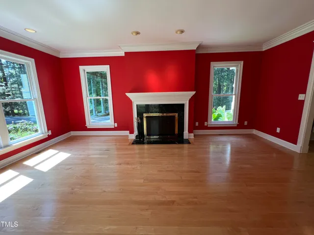 a view of empty room with fireplace and window
