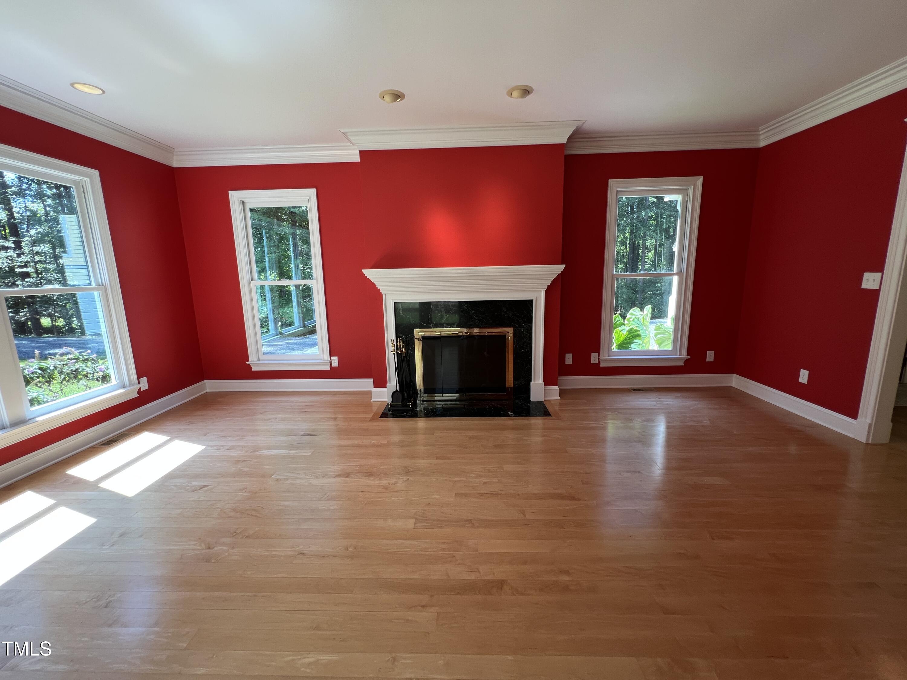 1208 Goodwin Road Apex, NC 27523 - Photo 13 of 42 a view of empty room with fireplace and window