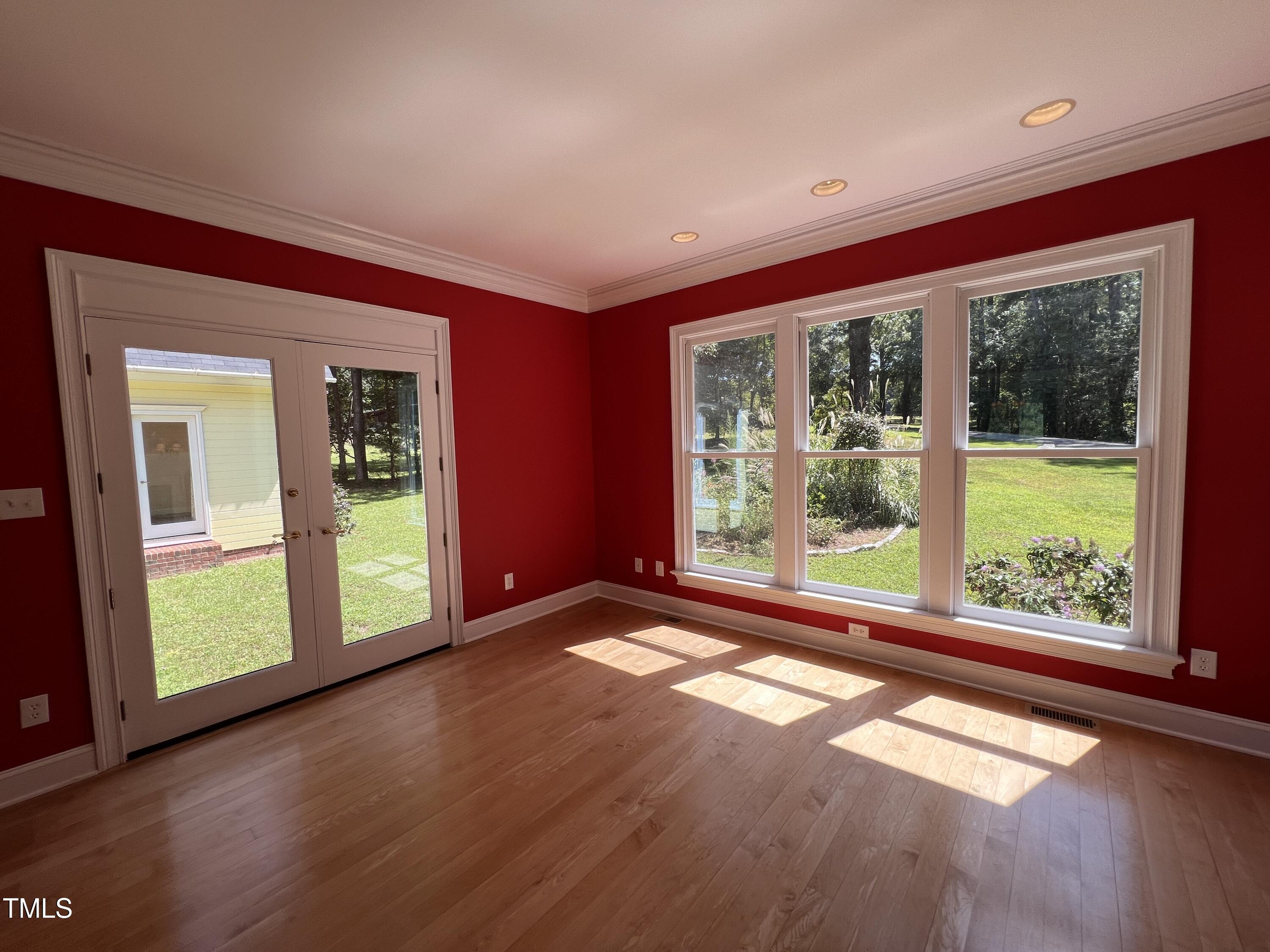 1208 Goodwin Road Apex, NC 27523 - Photo 15 of 42 a view of an empty room with wooden floor and a window