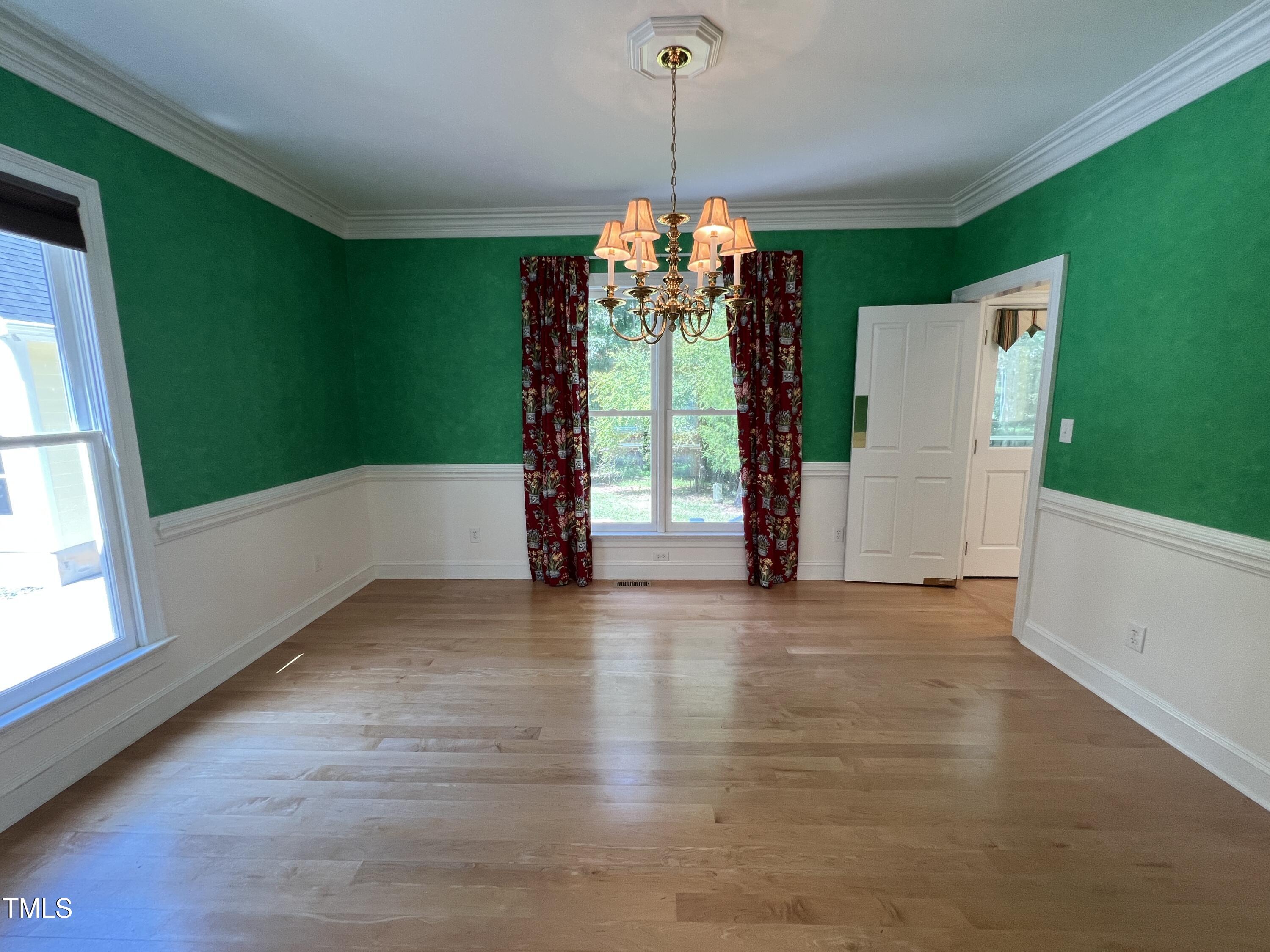 1208 Goodwin Road Apex, NC 27523 - Photo 16 of 42 a view of a room with window wooden floor and front door