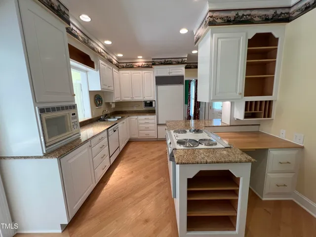 a kitchen with stainless steel appliances granite countertop a stove and a refrigerator