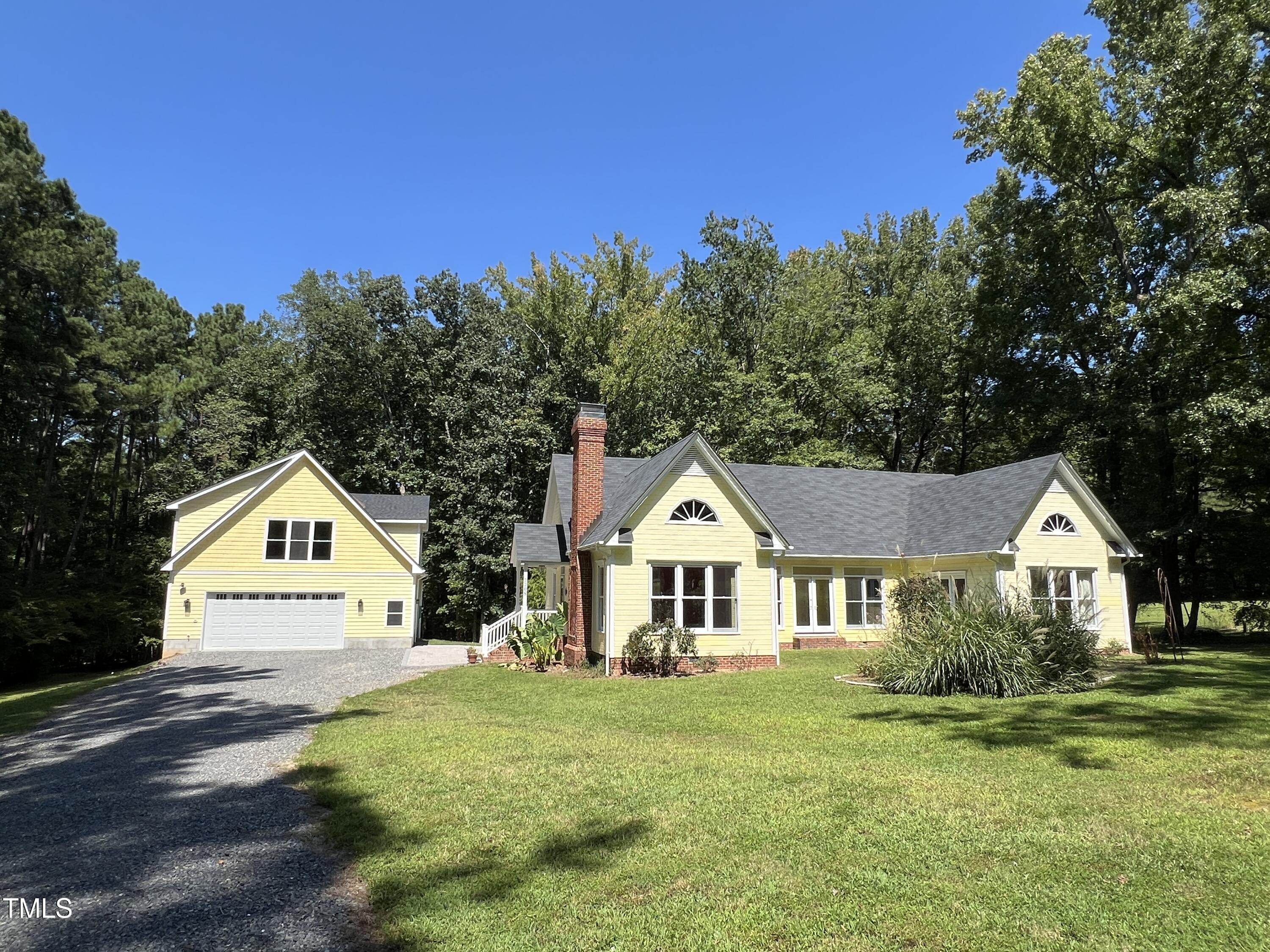 1208 Goodwin Road Apex, NC 27523 - Photo 2 of 42 a view of house with garden and trees in the background