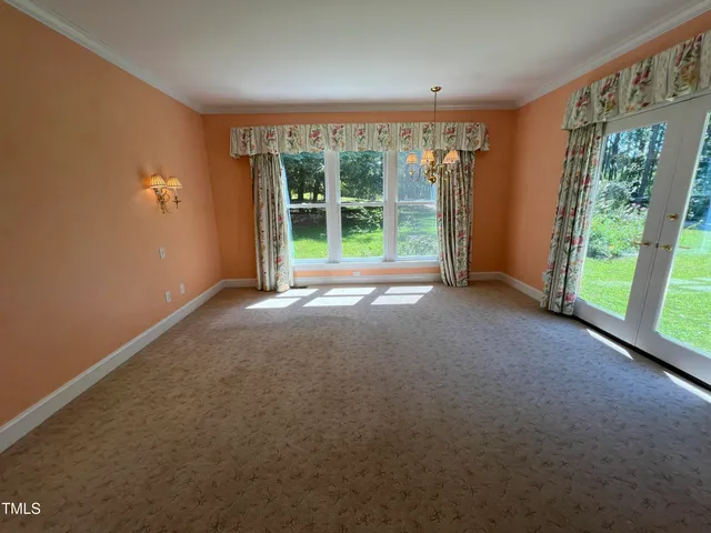 a view of a big room with windows and yard