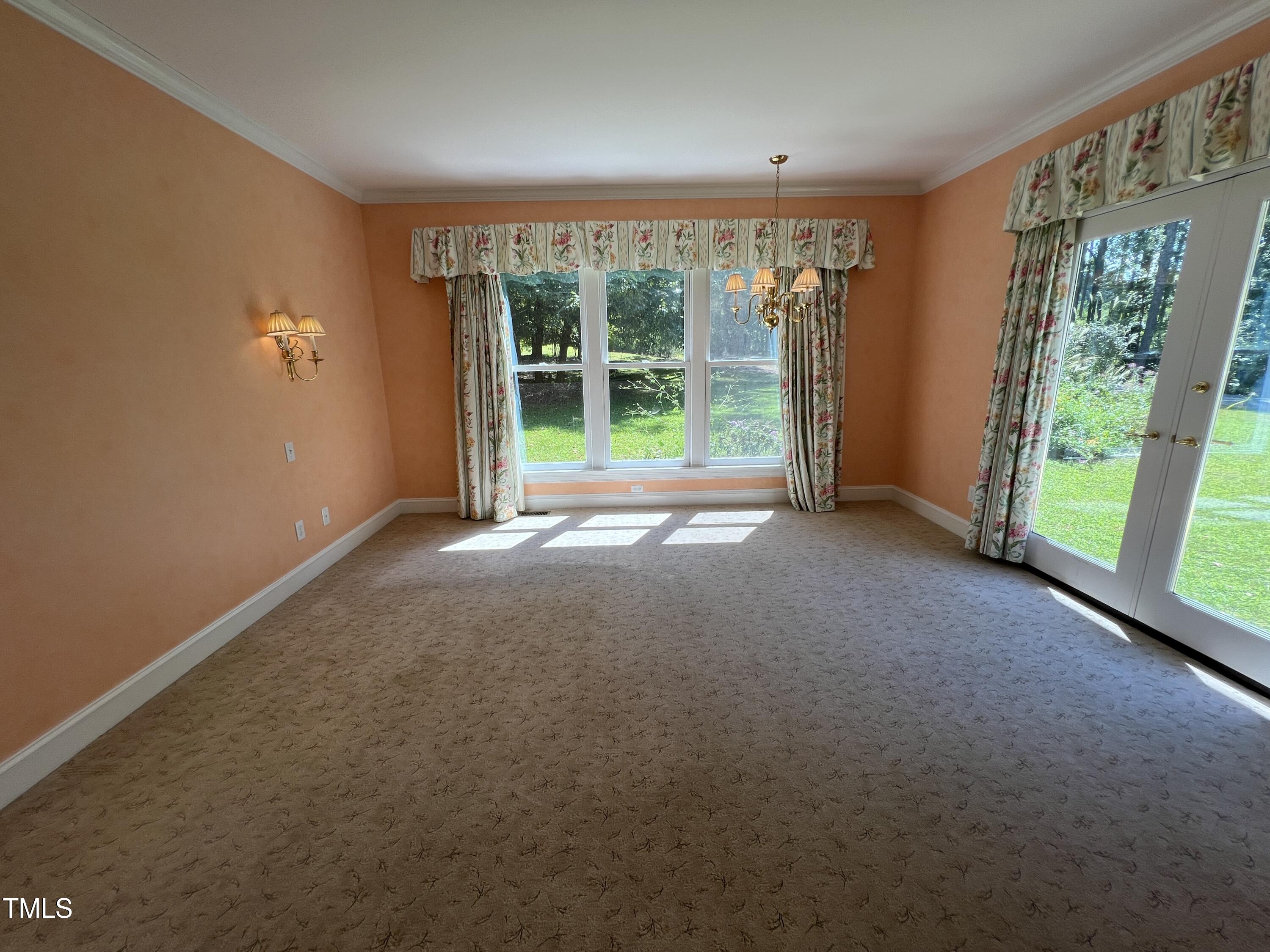 1208 Goodwin Road Apex, NC 27523 - Photo 27 of 42 a view of a big room with windows and yard