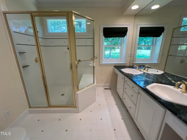 a bathroom with a granite countertop sink mirror and a bathtub