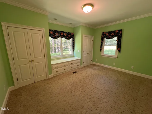 a view of an empty room and a window