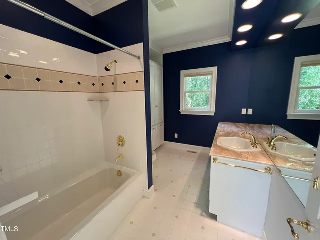 a bathroom with a granite countertop sink a toilet and bathtub