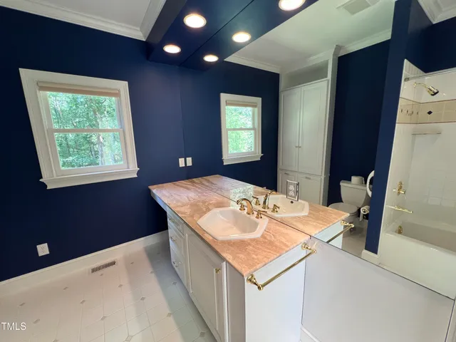 a kitchen that has a sink and a table in it