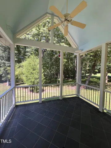 a view of a porch with wooden floor and iron stairs