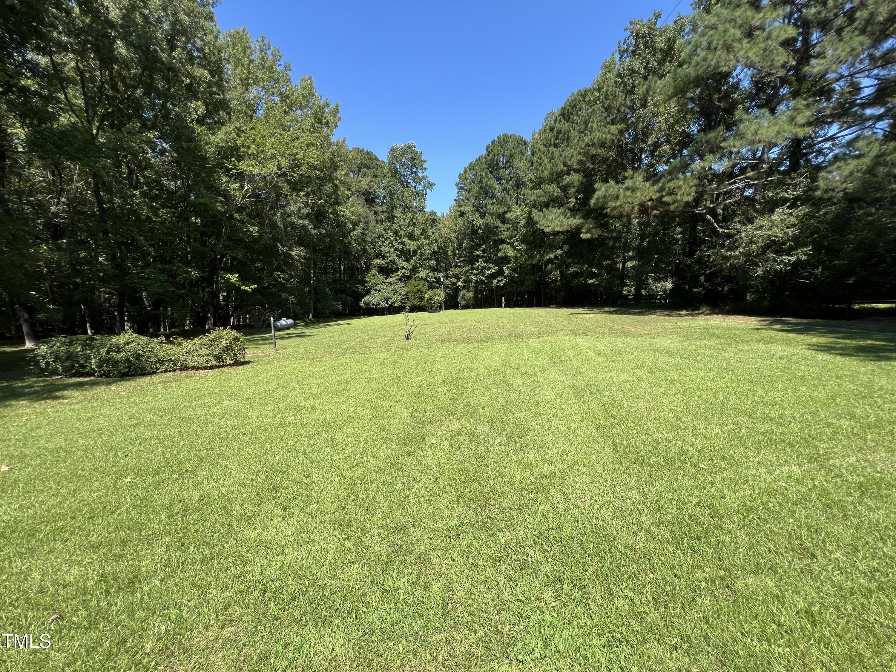 1208 Goodwin Road Apex, NC 27523 - Photo 6 of 42 a view of a field with an trees