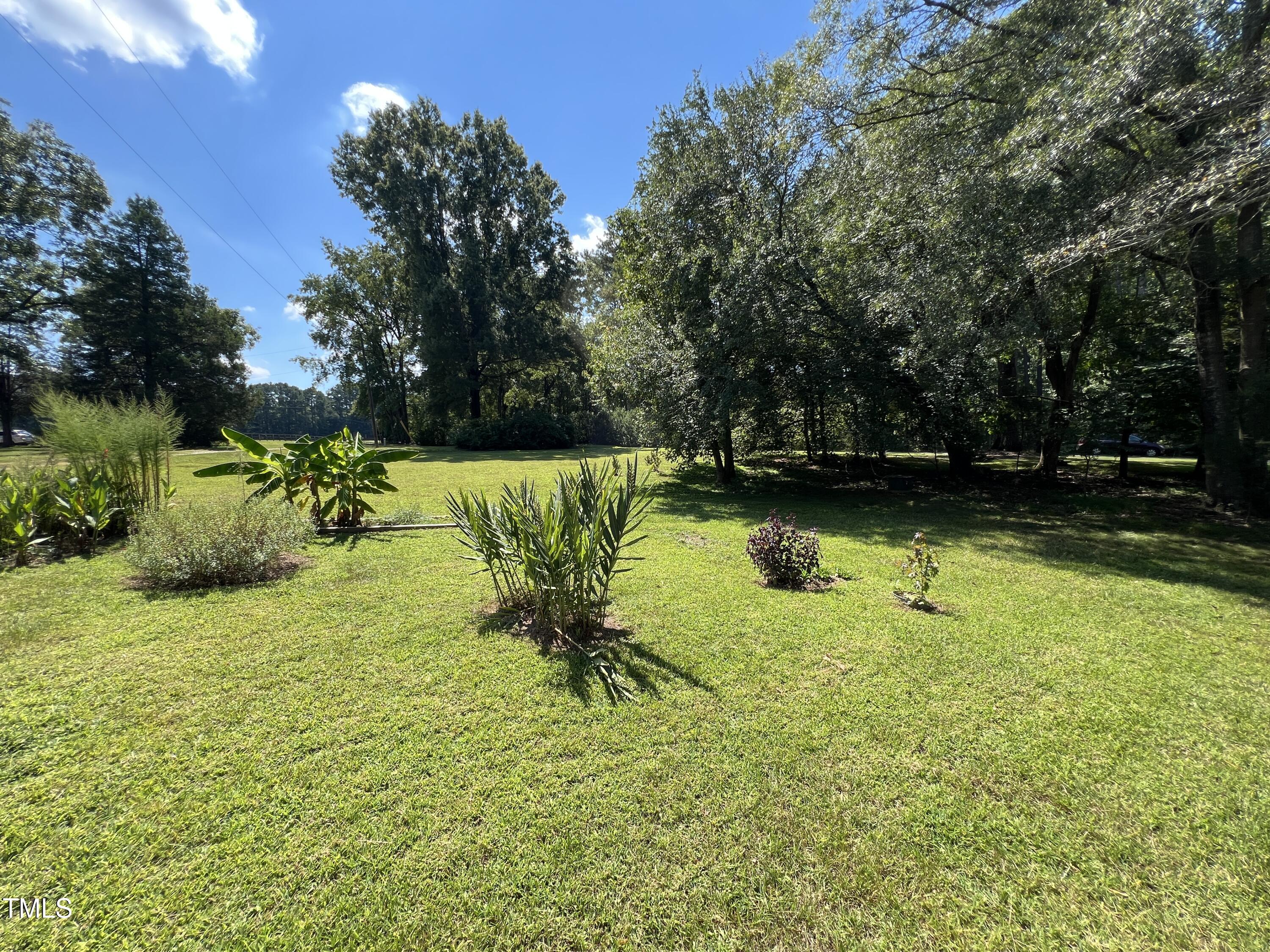 1208 Goodwin Road Apex, NC 27523 - Photo 7 of 42 a view of a lake with a yard