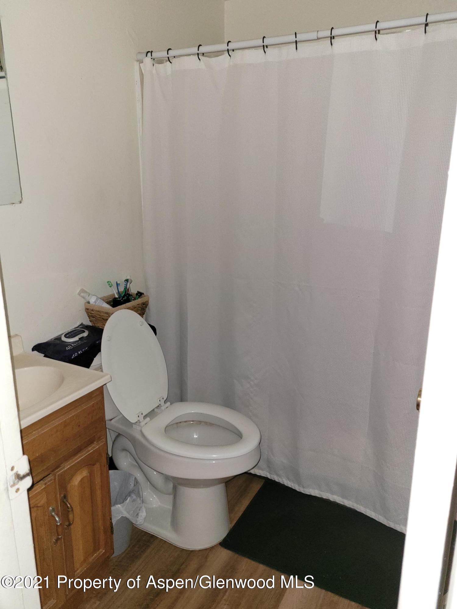 710 East 3rd Street Rifle, CO 81650 - Photo 5 of 9 a toilet sitting in a bathroom next to a sink
