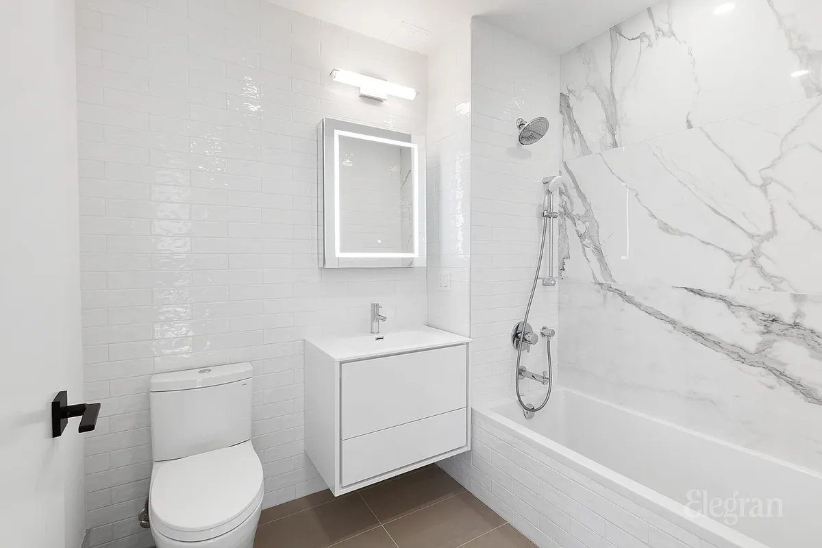 10-64 Jackson Avenue, Unit 4B Queens, NY 11101 - Photo 7 of 10 a bathroom with a toilet sink and shower