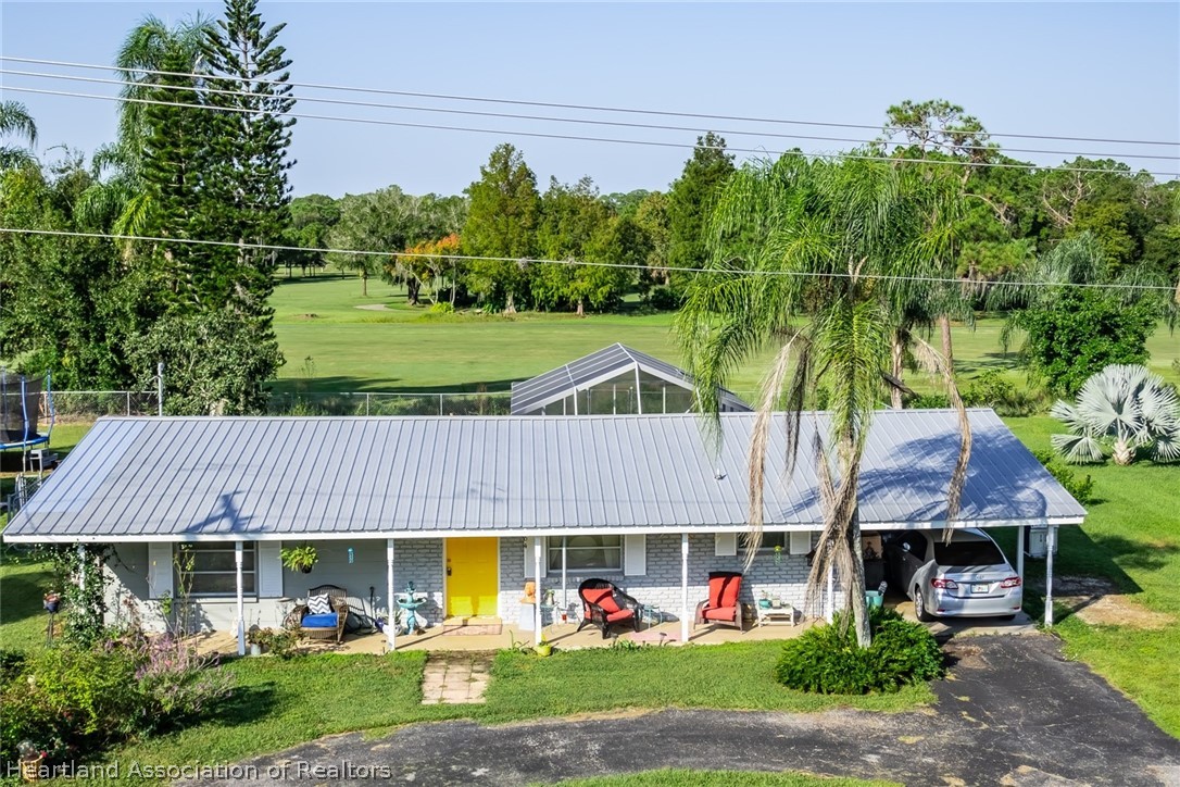 3264 Golfview Road Sebring, FL 33875 - Photo 1 of 27 an aerial view of a house with a yard garden and swimming pool