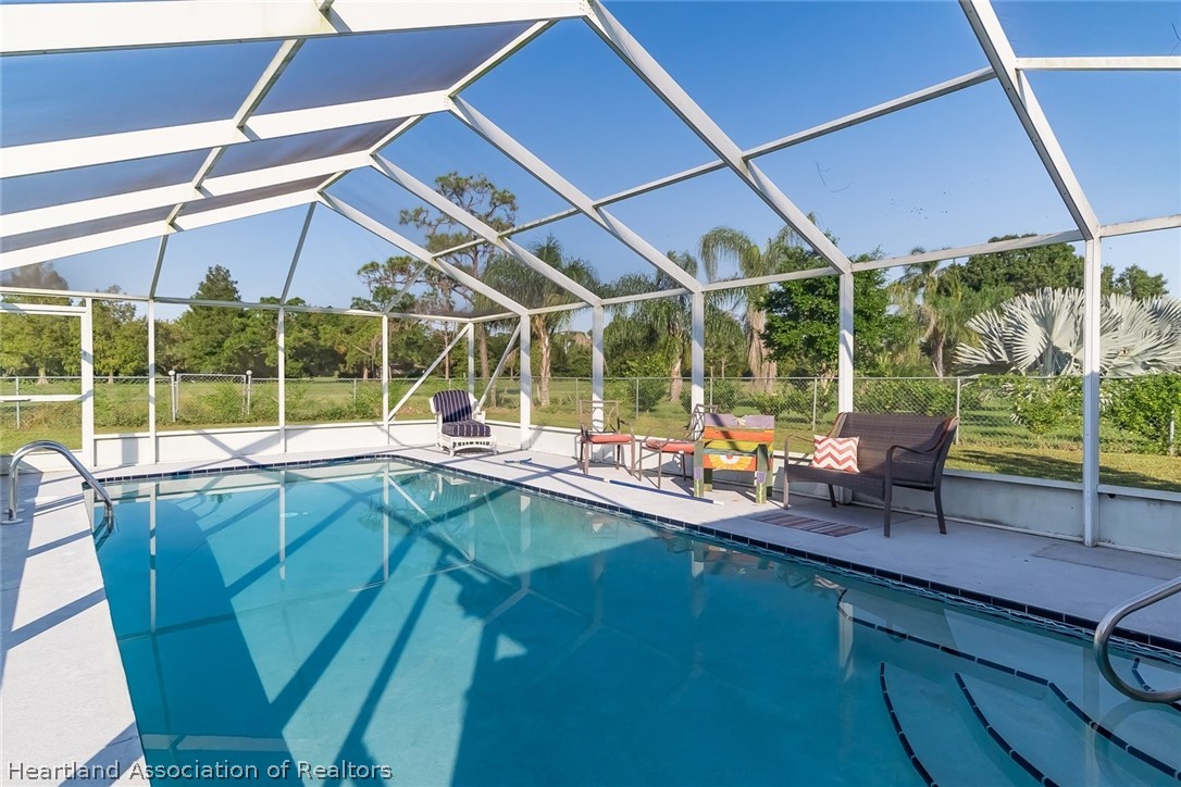 3264 Golfview Road Sebring, FL 33875 - Photo 20 of 27 a view of a patio with table and chairs under an umbrella