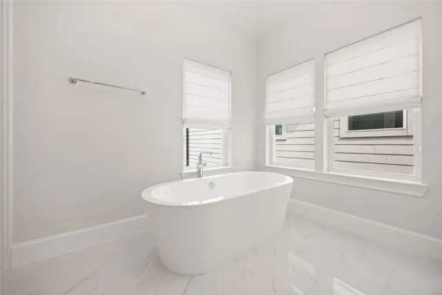 a white bath tub sitting next to a window
