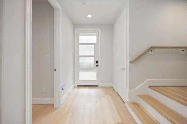 a view of a room with wooden floor and staircase
