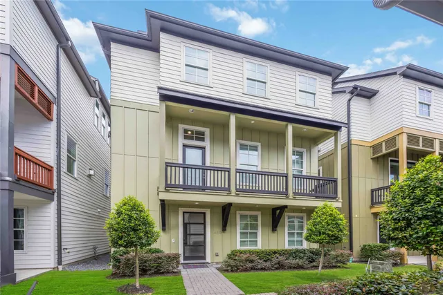 a view of a white building among the yard and large windows