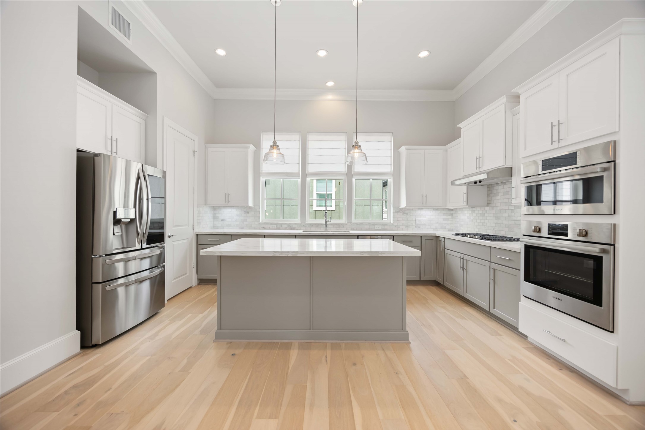 610 Delmar Street Houston, TX 77023 - Photo 3 of 27 a large kitchen with stainless steel appliances a large counter top a stove a sink and a refrigerator