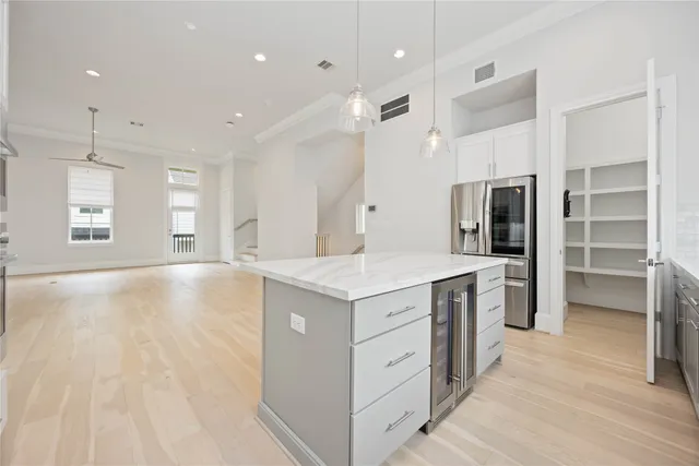 a kitchen with a stove a refrigerator and a sink