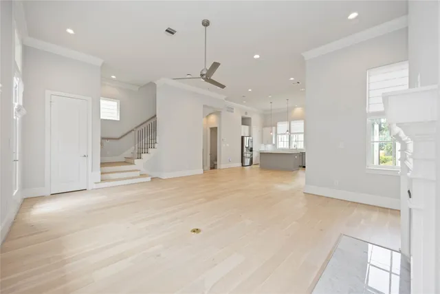 a view of an empty room and kitchen view