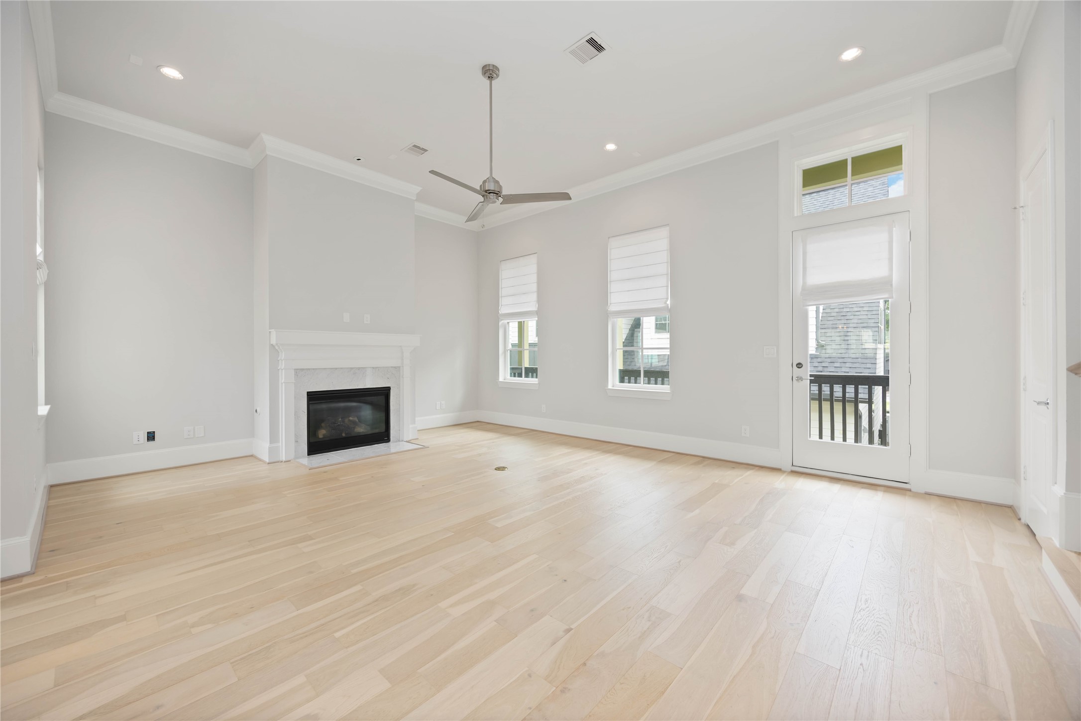 610 Delmar Street Houston, TX 77023 - Photo 8 of 27 an empty room with wooden floor fireplace and windows