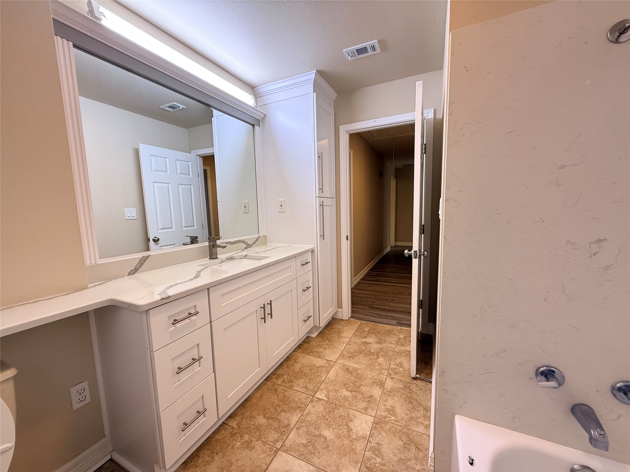 602 Cole Street Webster, TX 77598 - Photo 11 of 18 a bathroom with a double vanity sink and mirror with bathtub