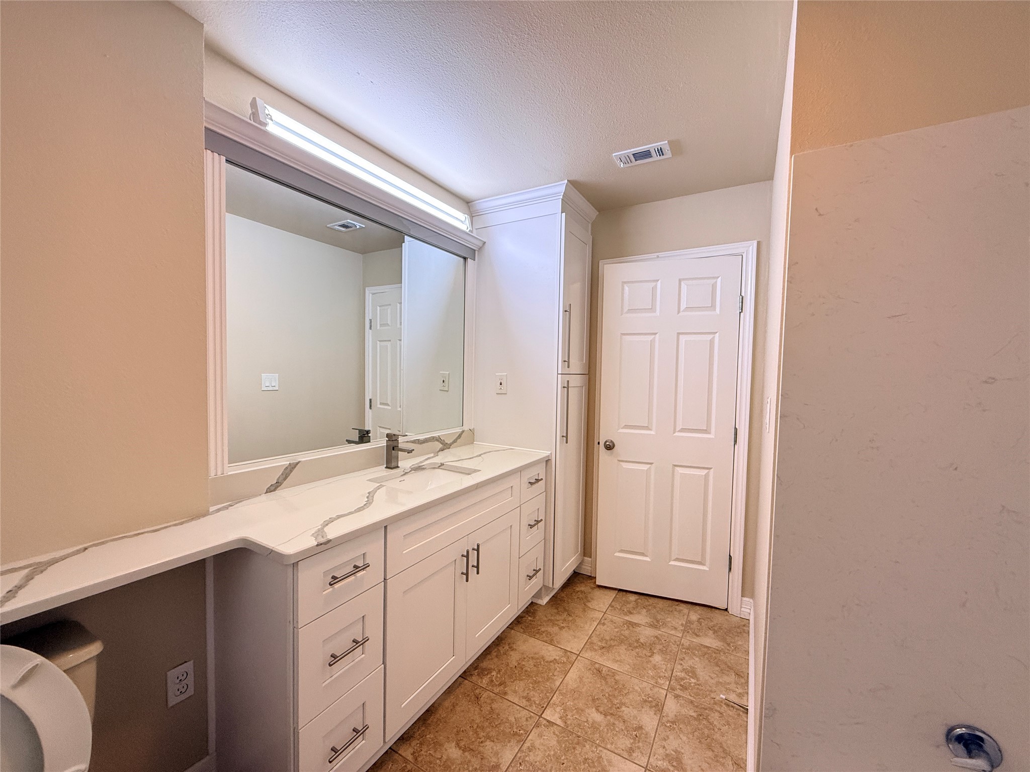 602 Cole Street Webster, TX 77598 - Photo 12 of 18 a spacious bathroom with a double vanity sink and a mirror