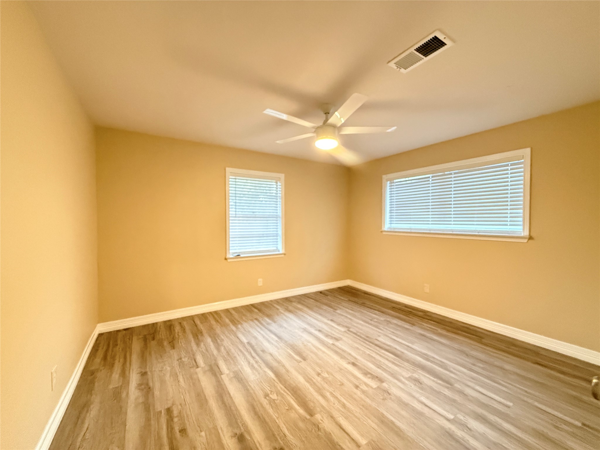 602 Cole Street Webster, TX 77598 - Photo 13 of 18 a view of an empty room with wooden floor and a window