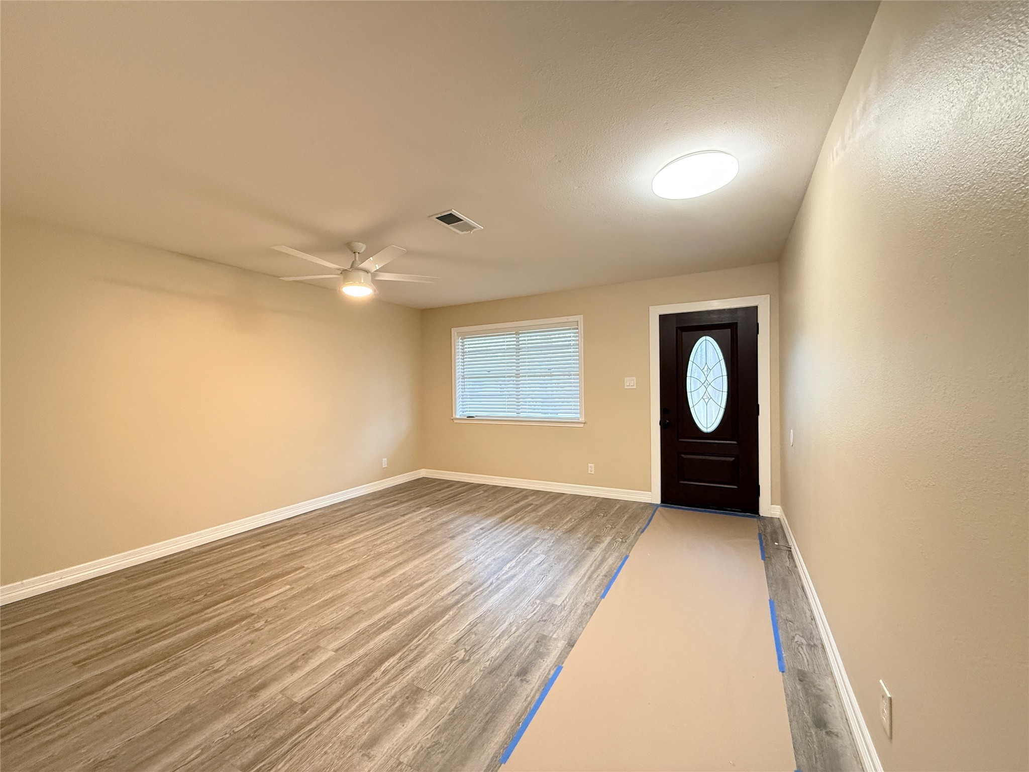 602 Cole Street Webster, TX 77598 - Photo 3 of 18 an empty room with wooden floor and windows