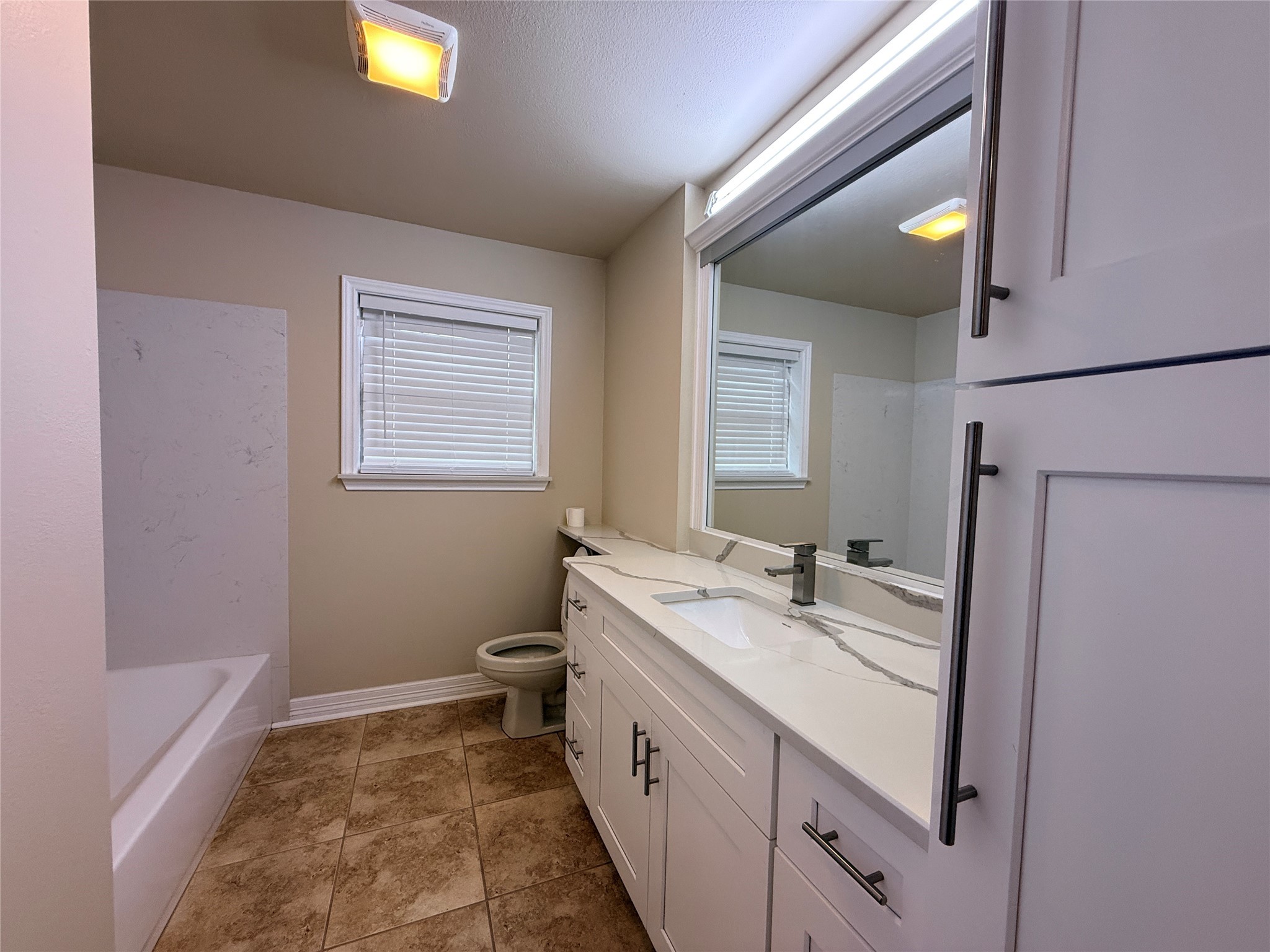 602 Cole Street Webster, TX 77598 - Photo 10 of 18 a bathroom with a sink a toilet and a mirror