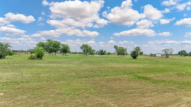 a view of a field with an ocean view