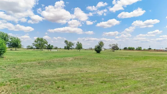 a view of a field with an ocean view