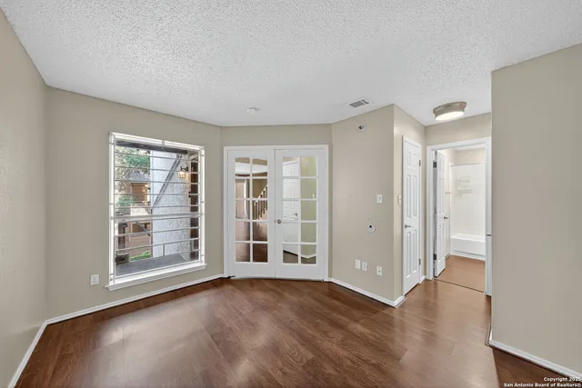 a bathroom with a granite countertop sink a toilet a mirror a bathtub and shower