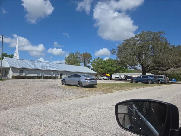 a view of a street with a car parked on the road