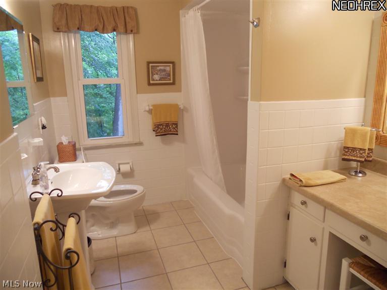 1910 Temblethurst Road South Euclid, OH 44121 - Photo 8 of 13 Updated Full Bath with Ceramic Tile Flooring, Pedestal sink, Shower over Tub and Make up Table