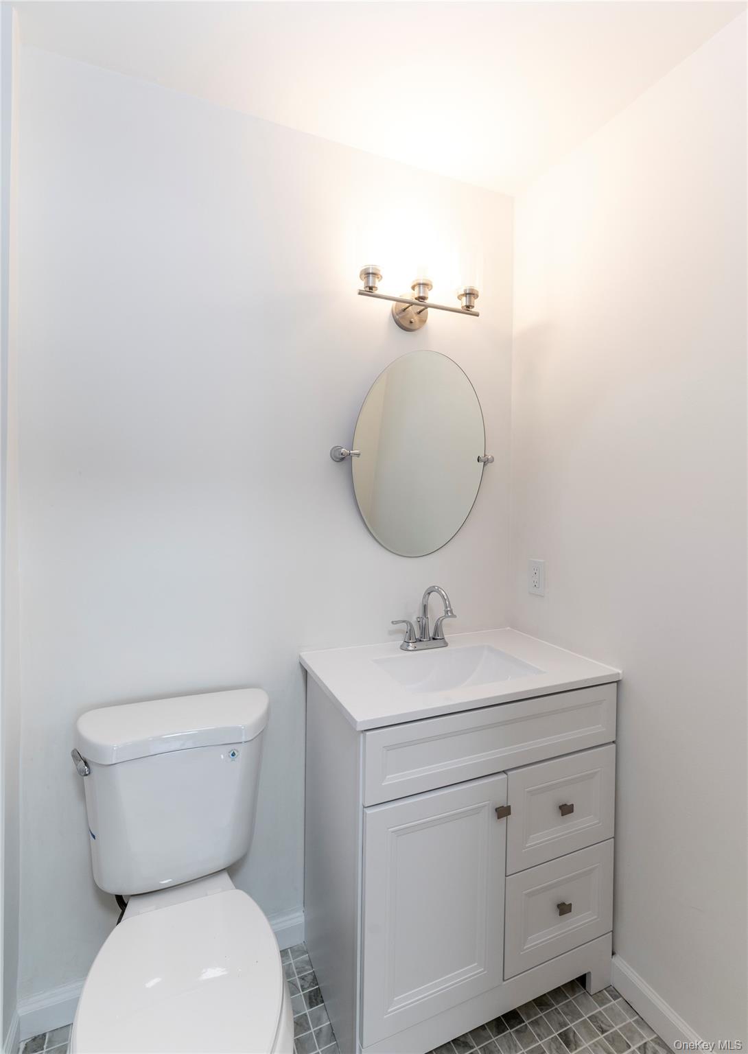 126 North Rte 303, Unit 2 Congers, NY 10920 - Photo 11 of 21 a bathroom with a toilet a sink and mirror
