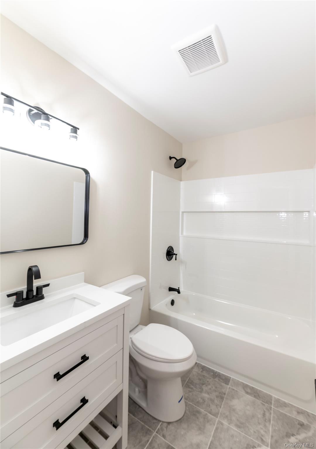 126 North Rte 303, Unit 2 Congers, NY 10920 - Photo 14 of 21 a bathroom with a toilet a sink a mirror and bathtub