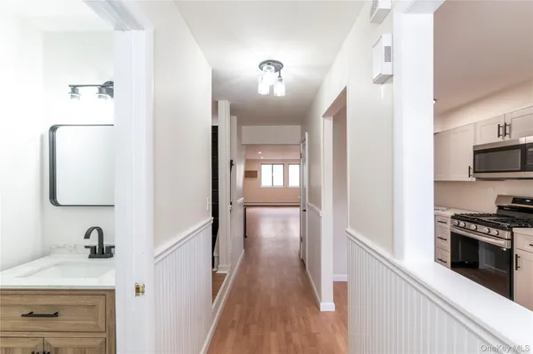 a view of a kitchen from a hallway