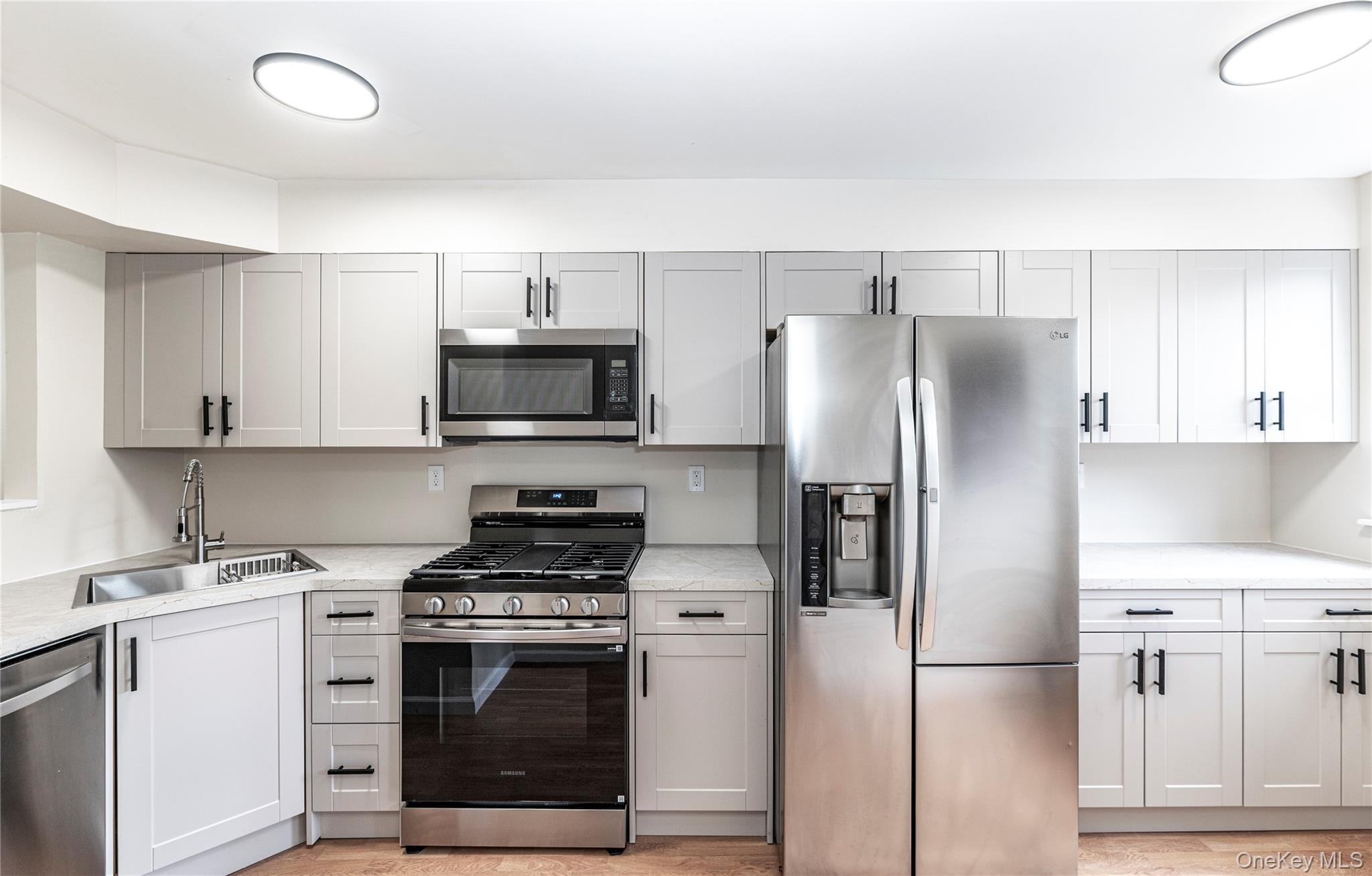 126 North Rte 303, Unit 2 Congers, NY 10920 - Photo 4 of 21 a kitchen with stainless steel appliances a refrigerator stove and microwave