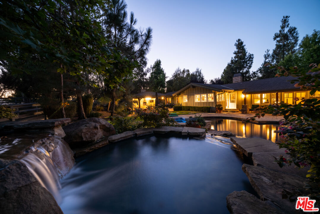 a view of swimming pool outdoor seating and city view