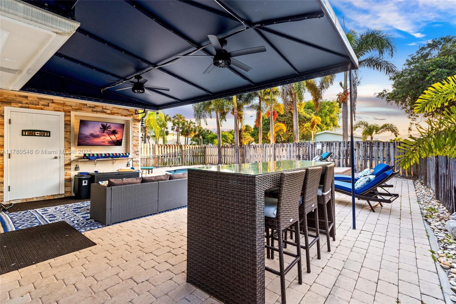 2231 Northeast 38th Street Lighthouse Point, FL 33064 - Photo 15 of 18 a view of a patio with a table and chairs