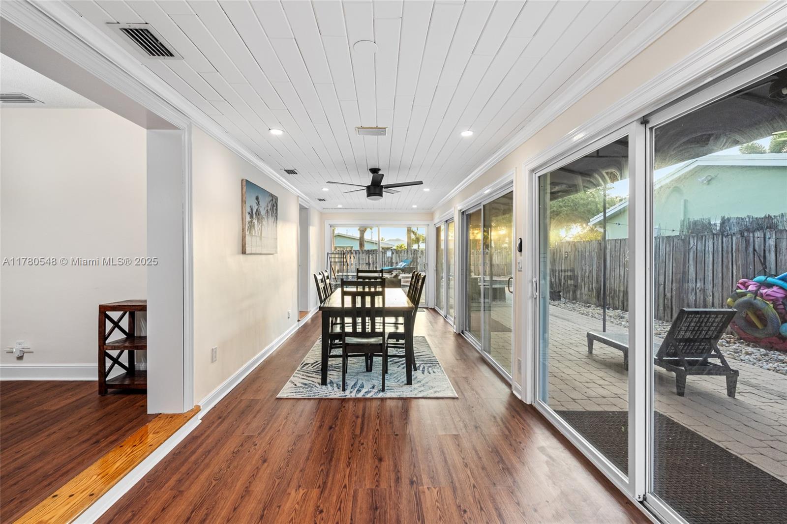 2231 Northeast 38th Street Lighthouse Point, FL 33064 - Photo 6 of 18 a view of a hallway with wooden floor and furniture