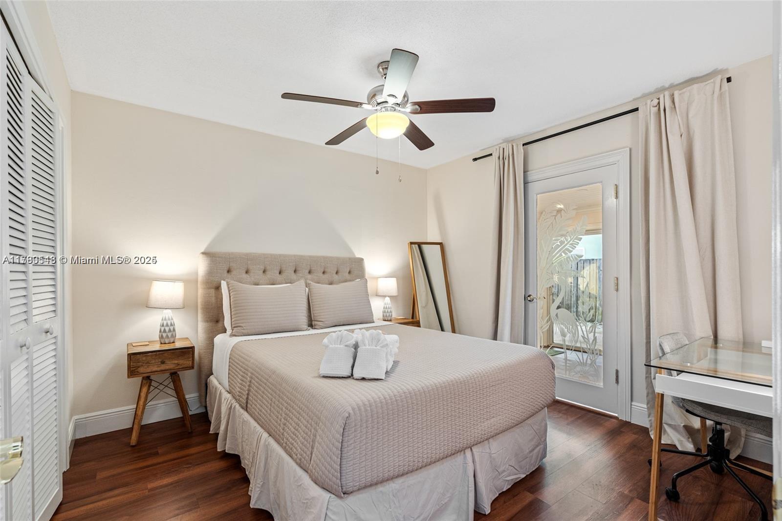2231 Northeast 38th Street Lighthouse Point, FL 33064 - Photo 10 of 18 a bedroom with a bed and a chandelier