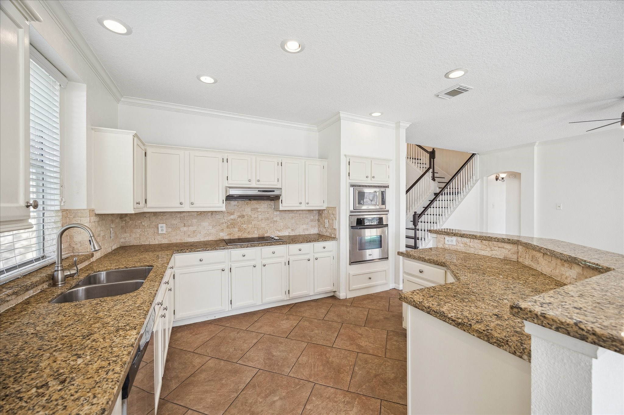 12831 Dove Point Lane Houston, TX 77041 - Photo 21 of 50 a kitchen with granite countertop sink and cabinets