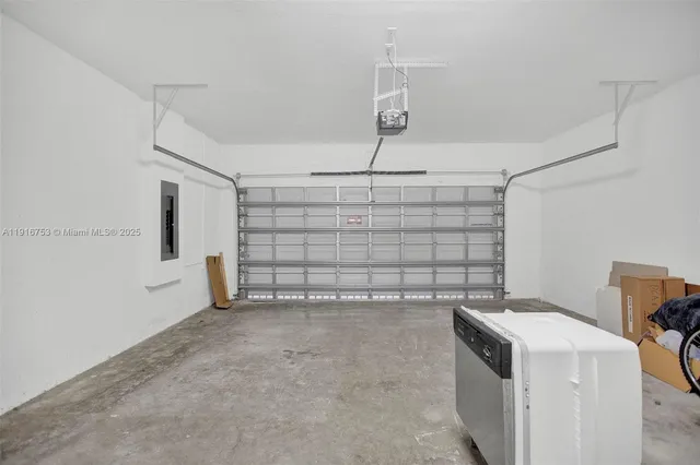 an empty room with windows and painting on the wall