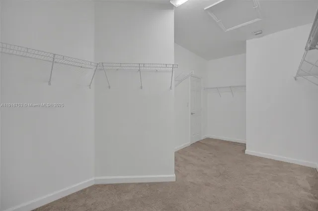 a white toilet sitting next to a white wall