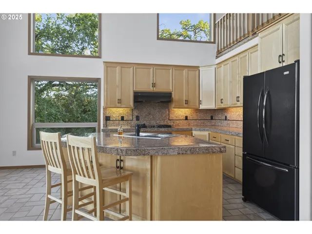 a kitchen with stainless steel appliances granite countertop a sink a stove and a microwave