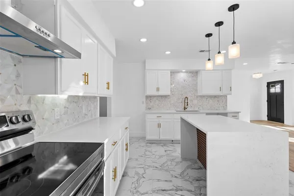 a kitchen with a sink stove and cabinets